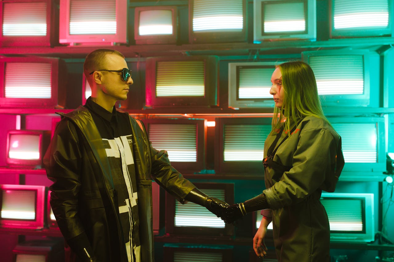 Two individuals with prosthetic arms engage in a handshake amidst a vibrant, retro television backdrop.